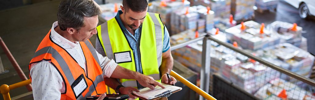 Employer speaking with employee in warehouse