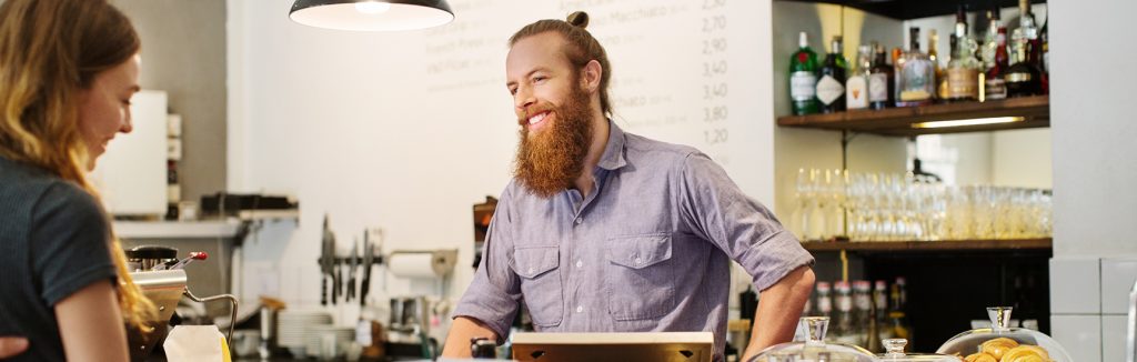 Happy hospitality worker serving customer