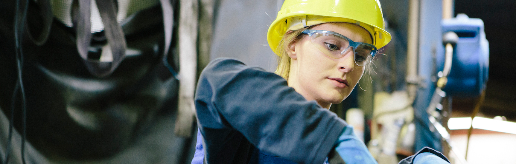 Apprentice working in workshop in safety equipment