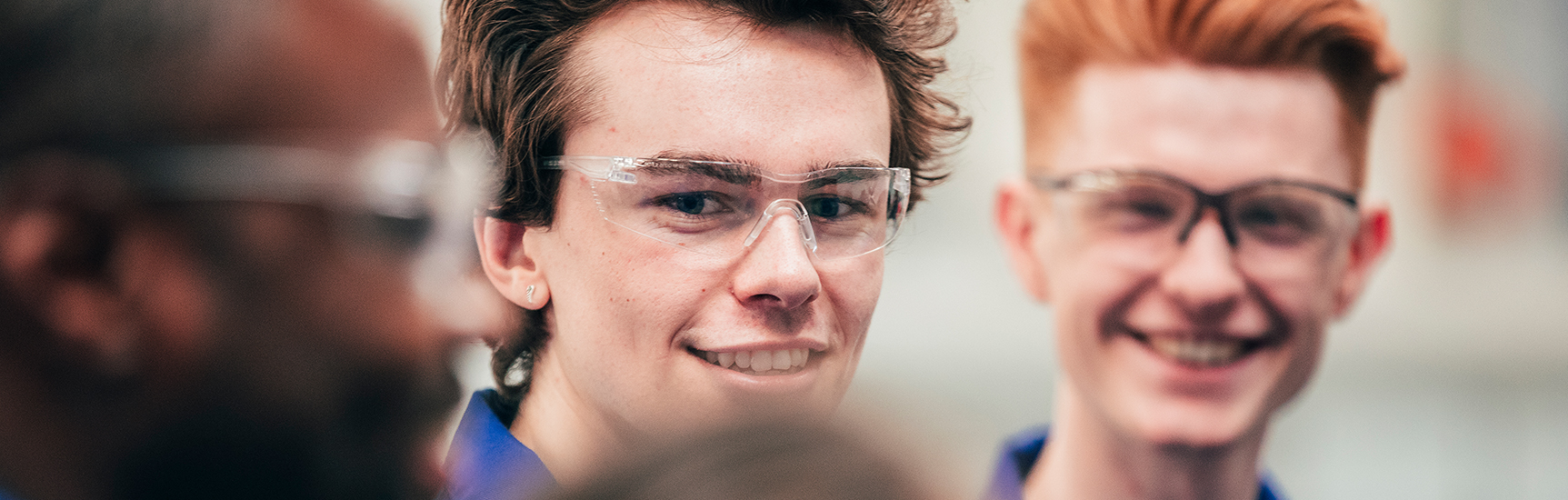 Happy apprentices in safety glasses